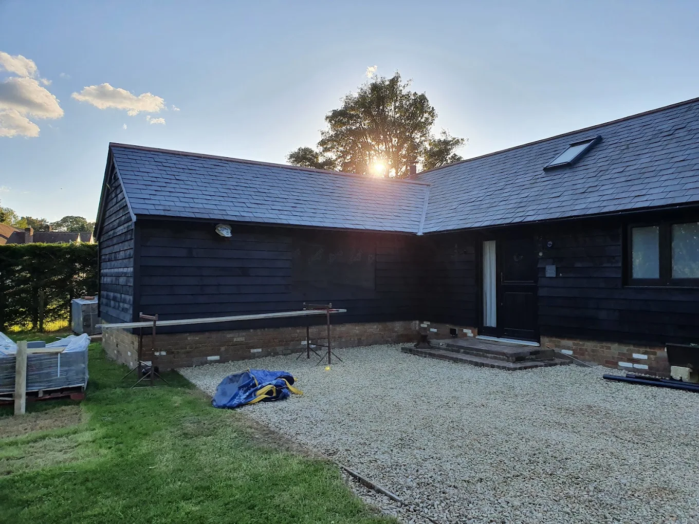 Finished black timber-clad barn conversion at sunset