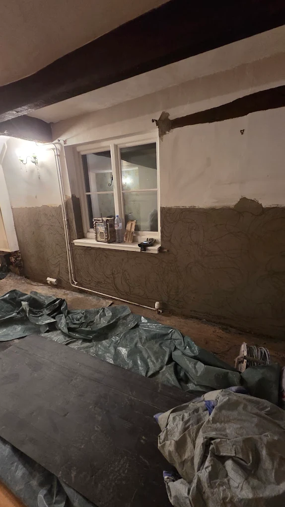 Lime plaster being applied to the wall of a period cottage