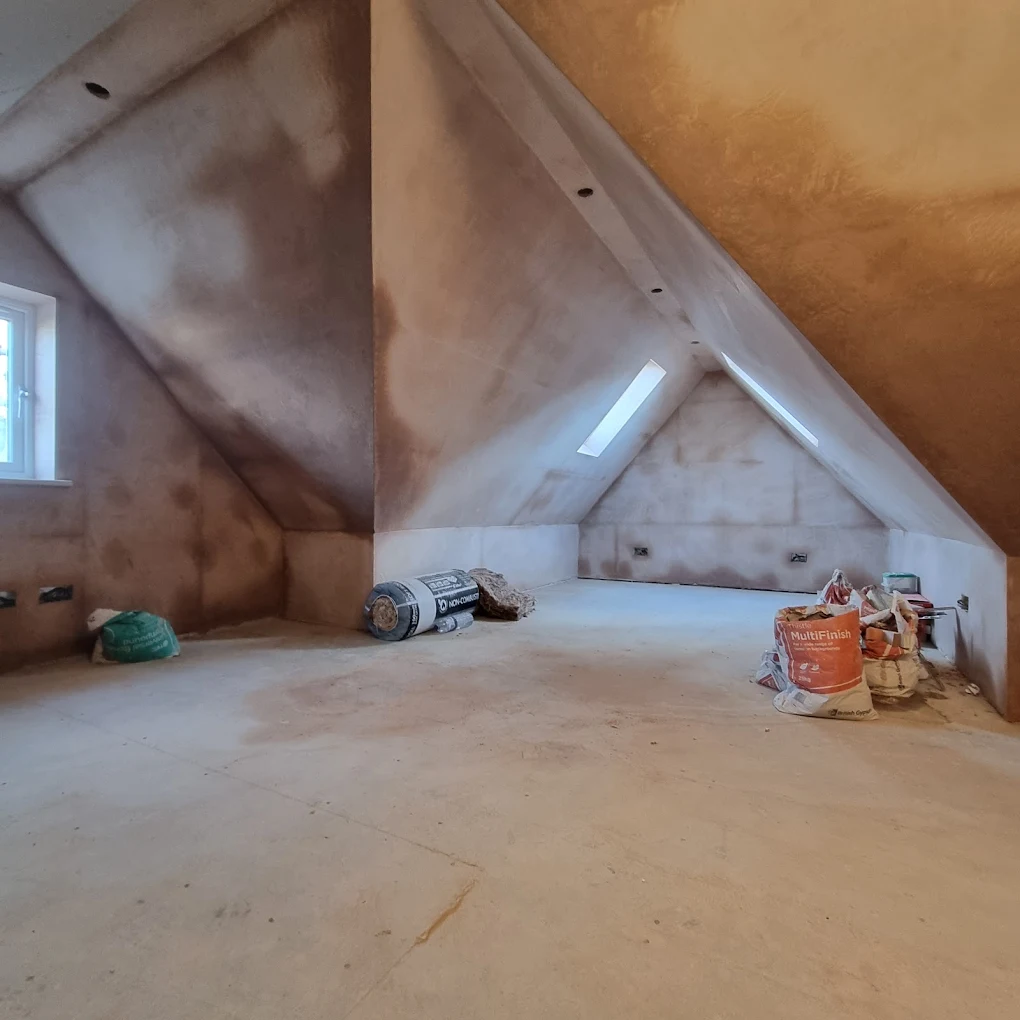Loft conversion with freshly plastered sloped ceilings